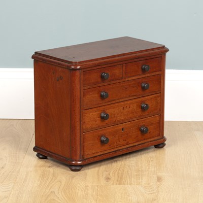 Lot 582 - A miniature chest of drawers