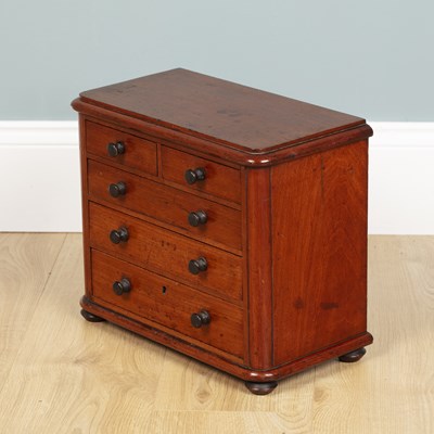 Lot 582 - A miniature chest of drawers