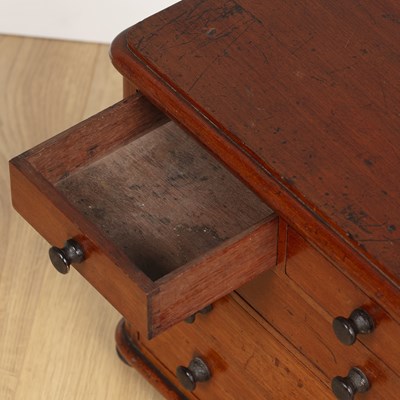 Lot 582 - A miniature chest of drawers