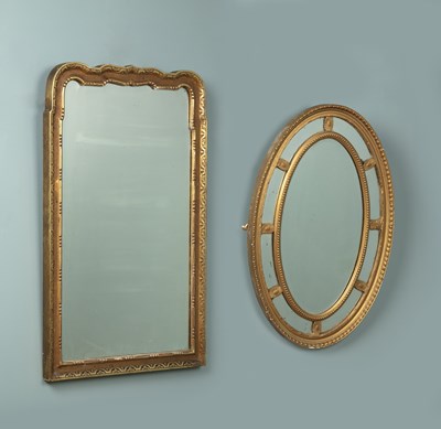 Lot 45 - A late 19th century gilded wall mirror together with an oval sectional glass wall mirror