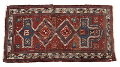 Lot 1250 - An antique Kazak polychrome rug