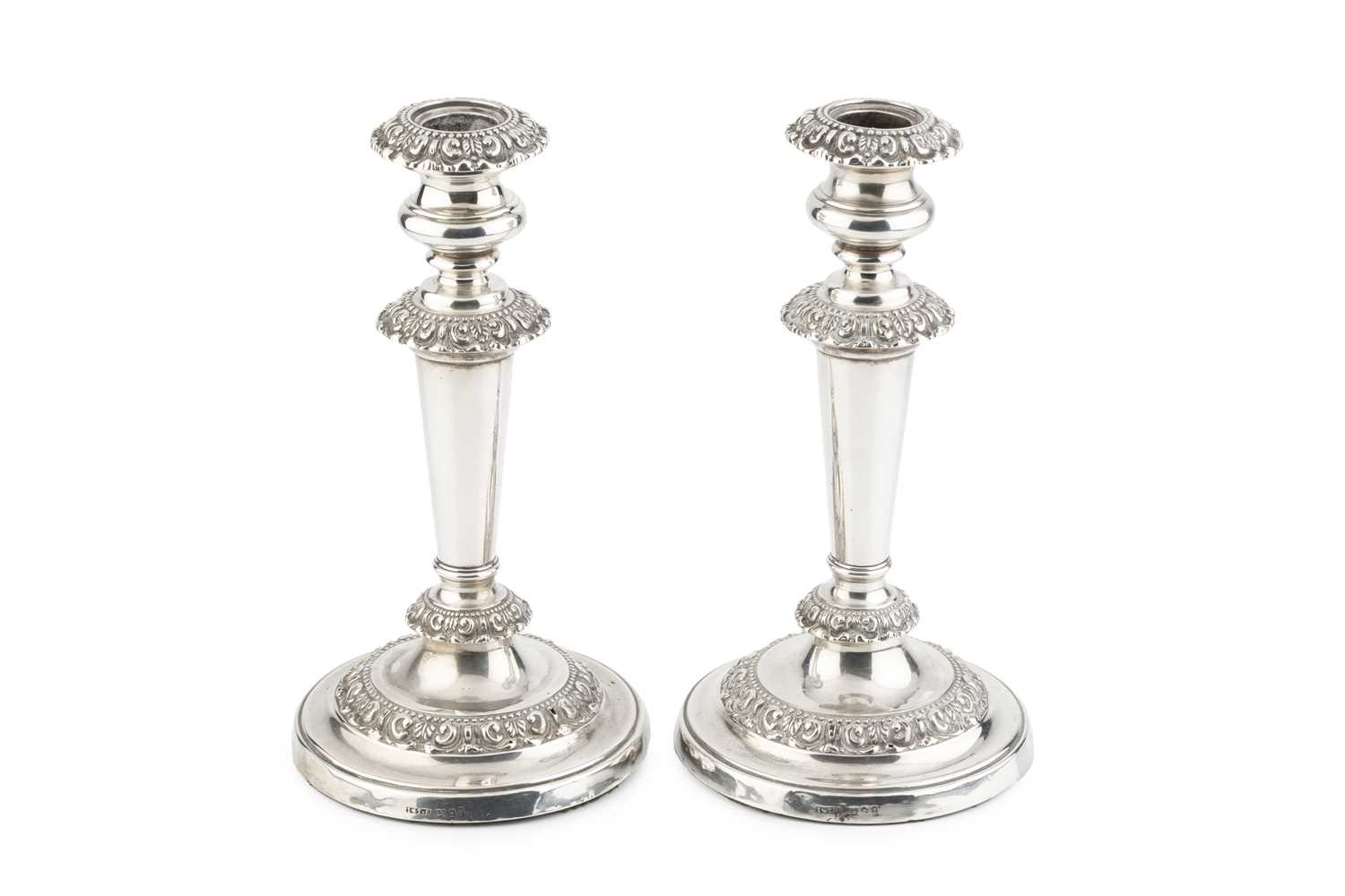 Lot 148 - A pair of George IV silver candlesticks, the...