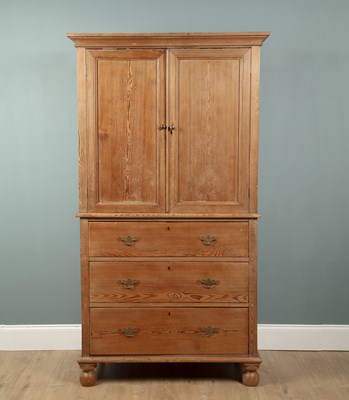 Lot 595 - A pitch pine linen press