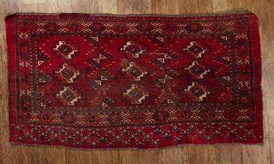 Lot 118 - Turkoman style rug of red ground, with three...