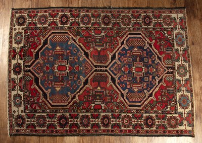 Lot 149 - Caucasian blue and red ground rug with two...