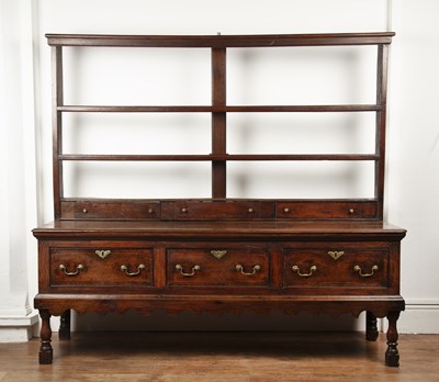 Lot 85 - Large oak dresser base with a later rack 18th...