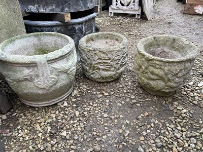Lot 1349 - A group of three cast reconstituted stone garden planters