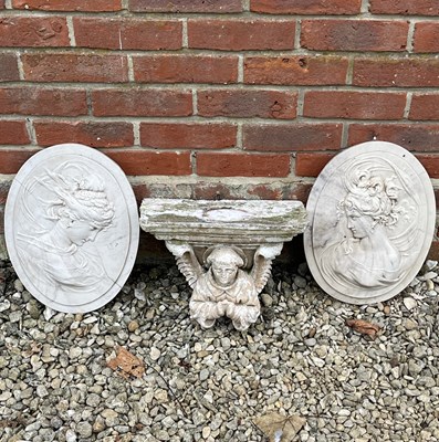 Lot 1355 - A decorative corbel together with two oval plaques