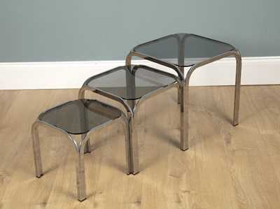 Lot 1097 - A set of three mid-century chrome-framed occasional tables