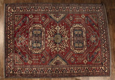 Lot 32 - Caucasian style rug  red ground, with an...