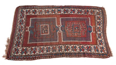 Lot 1301 - An early 20th century woollen hand-woven Kazak rug