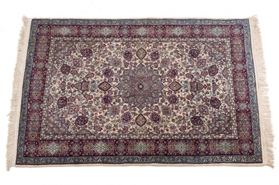 Lot 1246 - An old Qum cream ground rug