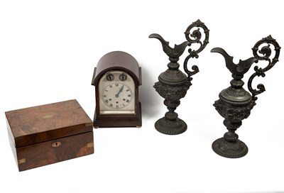 Lot 701 - A quarter-striking mantel clock; a pair of spelter ewers; and a walnut writing slope