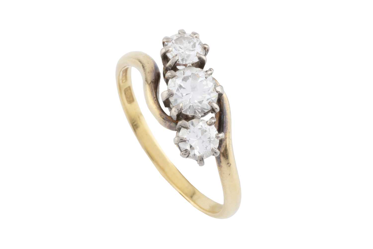 Lot 128 - A diamond three stone ring, of crossover...