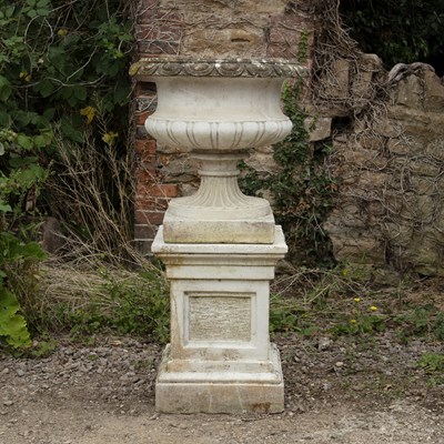 Lot 1474 - A garden urn on a plinth base