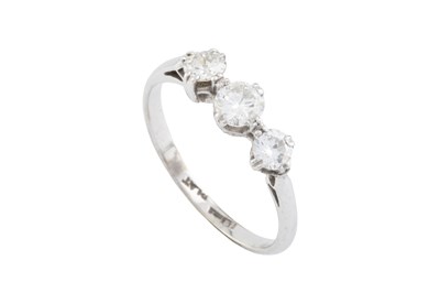 Lot 184 - A diamond three stone ring, the slightly...