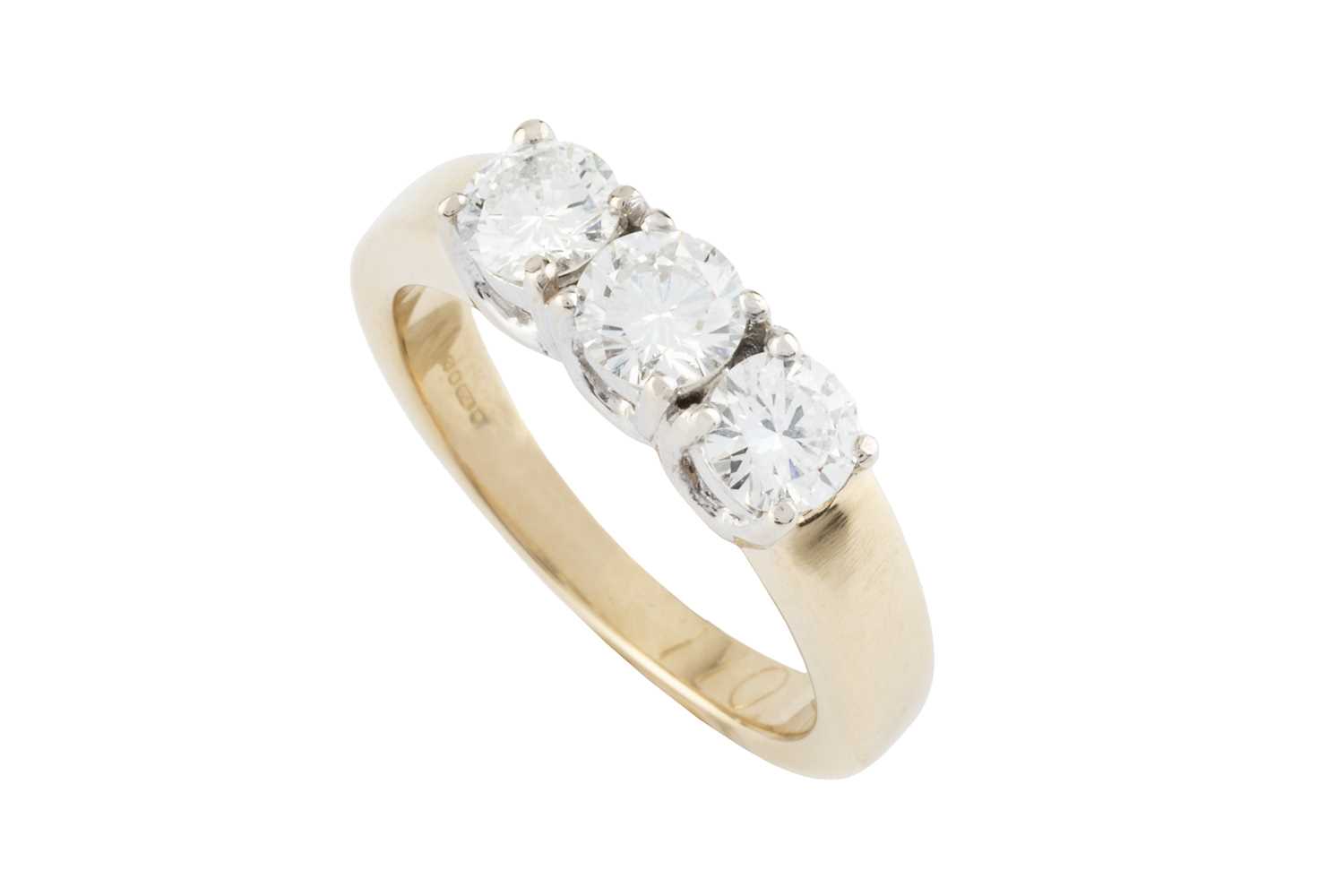 Lot 141 - A diamond three stone ring, the round...