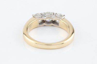 Lot 141 - A diamond three stone ring, the round...