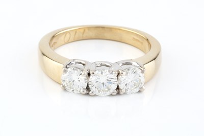 Lot 141 - A diamond three stone ring, the round...