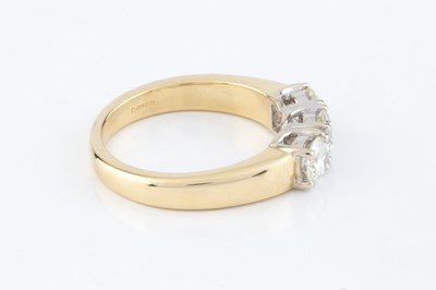 Lot 141 - A diamond three stone ring, the round...