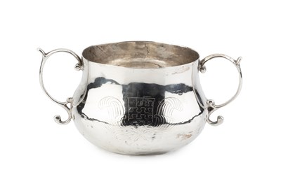 Lot A Charles II silver twin handled caudle cup,...