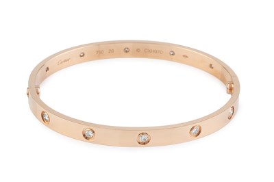 Lot 260 - A diamond set 'Love' bangle by Cartier, of...