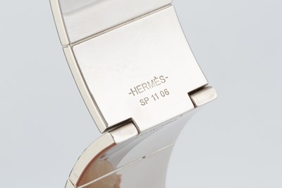 Lot 255 - An enamel 'Coup de Fouet' bangle by Hermès, of...