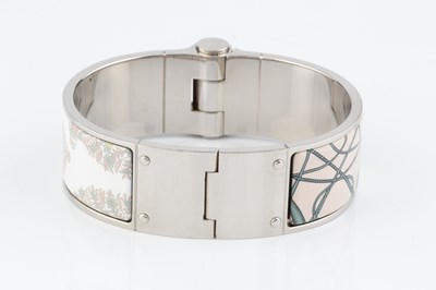 Lot 255 - An enamel 'Coup de Fouet' bangle by Hermès, of...