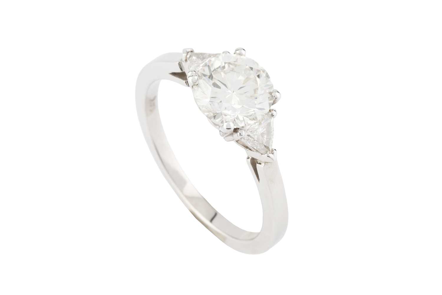 Lot 271 - A diamond three stone ring, the principal...
