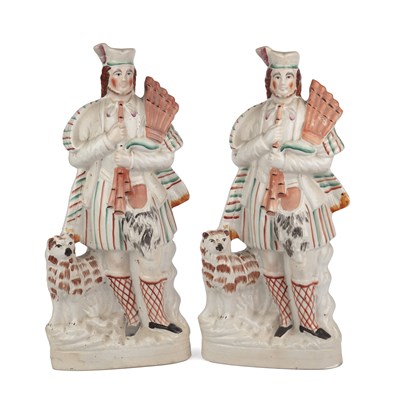 Lot 362 - A pair of Staffordshire Scottish bagpiper...