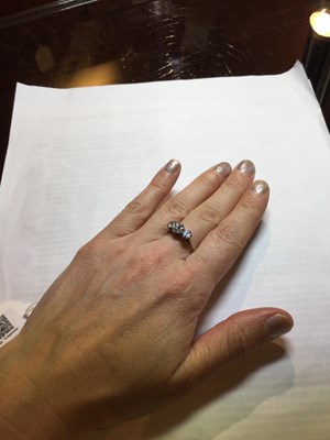 Lot 265 - A diamond three stone ring, the graduated...