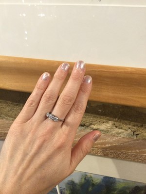 Lot 265 - A diamond three stone ring, the graduated...