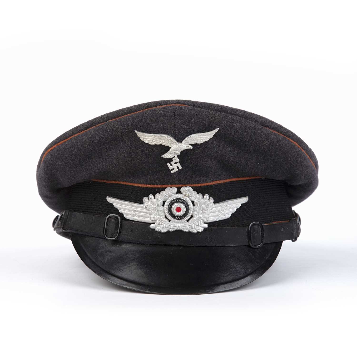 Lot 76 - A WWII German Luftwaffe signals visor cap, in...