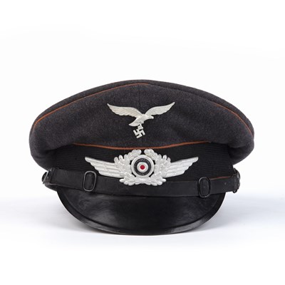 Lot 76 - A WWII German Luftwaffe signals visor cap, in...