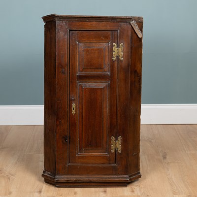 Lot 404 - An 18th century oak Country made corner cupboard