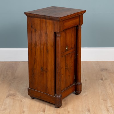 Lot 461 - A 19th century Empire-style yew wood bedside cupboard