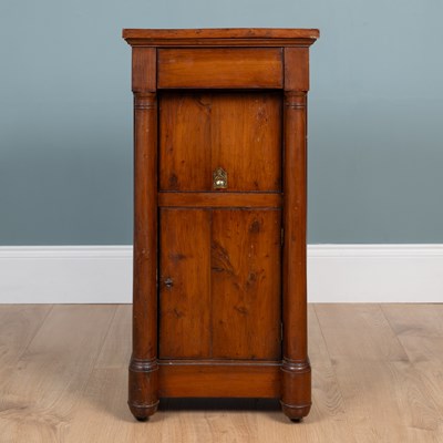 Lot 143 - A 19th century Empire-style yew wood bedside cupboard