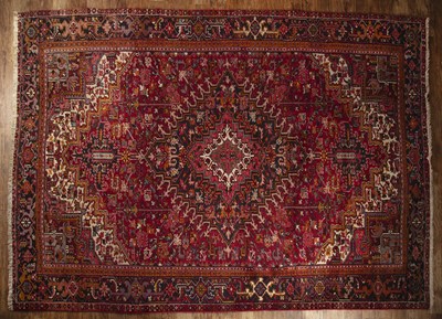 Lot 173 - Large red ground carpet Iran with a central...