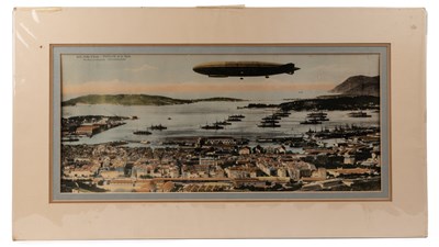 Lot A hand coloured photograph of a zeppelin over a harbour