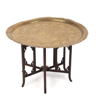 Lot 104 - A late 19th century eastern brass topped table...