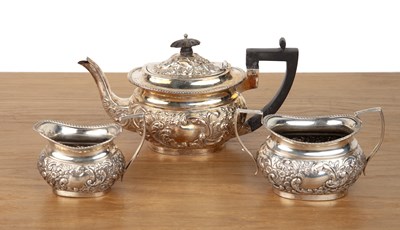 Lot Three piece silver tea set with repousse...