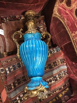 Lot 146 - A French faience turquoise oil lamp with...