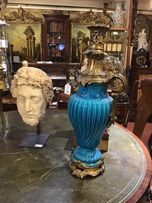 Lot 146 - A French faience turquoise oil lamp with...