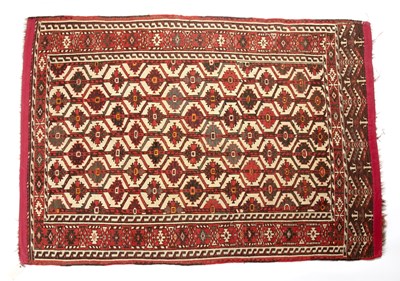 Lot 273 - An antique Turkmen red ground rug with a red...