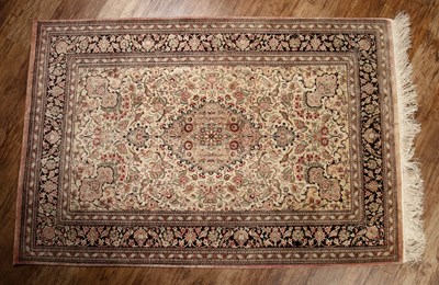 Lot 56 - Kashan silk ivory ground rug with a central...