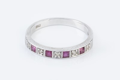 Lot 134 - A diamond and ruby half hoop ring, alternately...