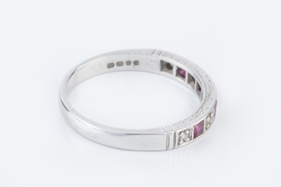 Lot 134 - A diamond and ruby half hoop ring, alternately...