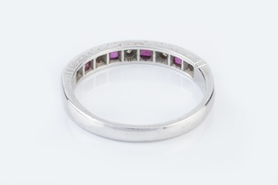Lot 134 - A diamond and ruby half hoop ring, alternately...