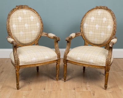 Lot 135 - A pair of 19th century French giltwood-framed oval-backed armchairs