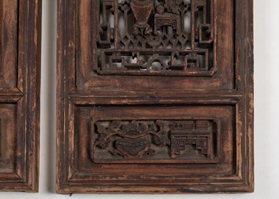 Lot 384 - A pair of Oriental hardwood carved panels.